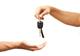 Hands giving motor car keys